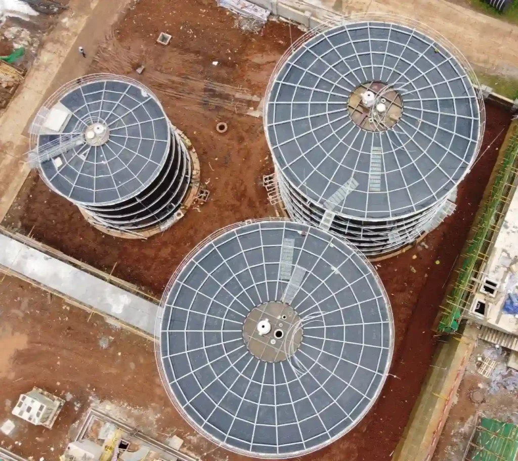 Aerial view of three biogas digesters with different diameters, illustrating stirrer sizing and agitation in digesters.