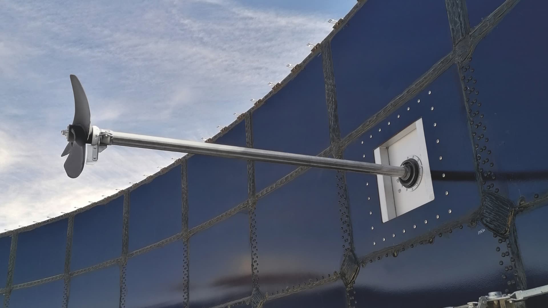 Biogas digester stirrer installed on the exterior of a large digester.